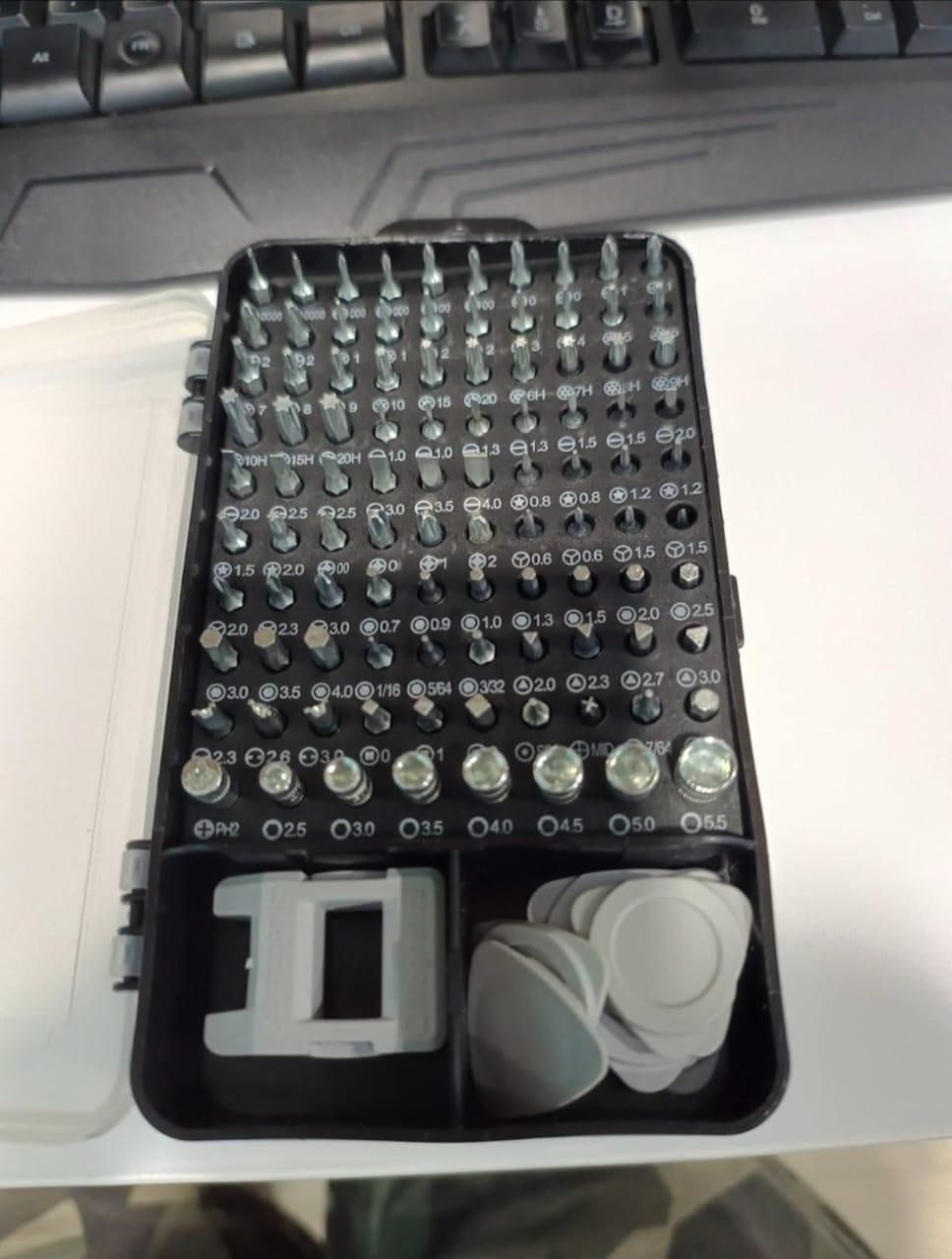 Compact appliance and gadget maintenance tool kit with various precision screwdriver bits and accessories in a black case