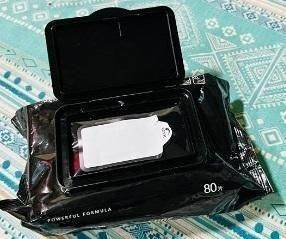 Package of 80 eco-friendly sneaker cleaner wipes in resealable black packaging on patterned surface