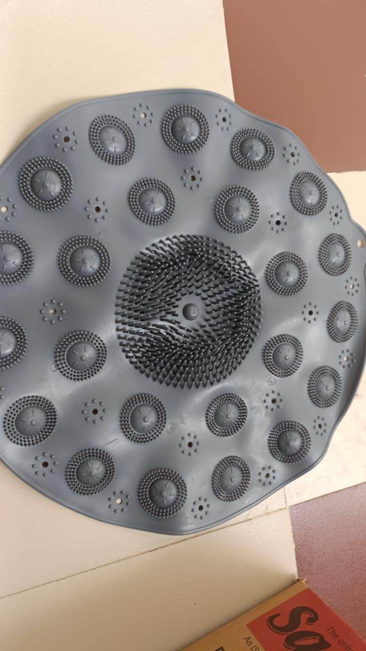 Gray foot scrubber mat for shower with textured bristles and suction cups for deep cleaning