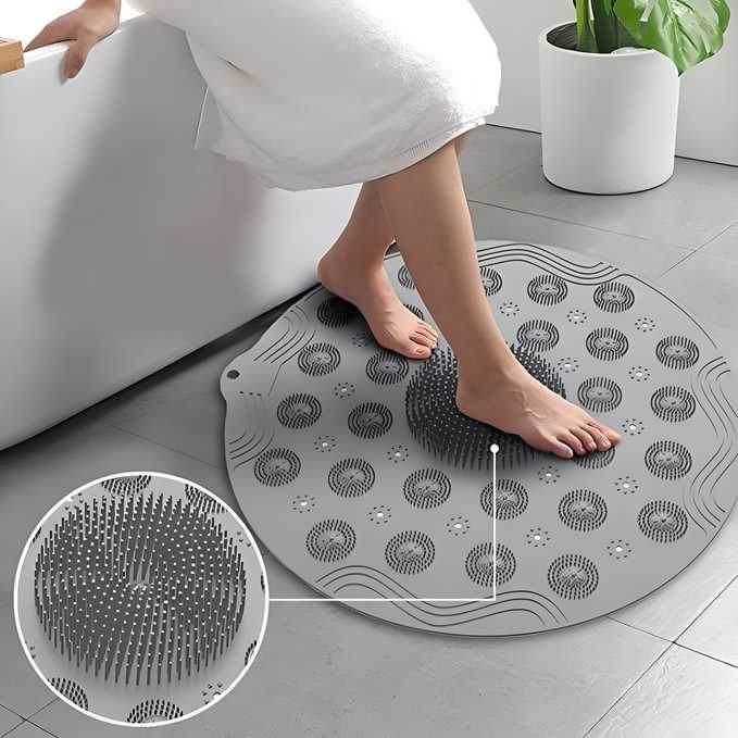 Gray foot scrubber mat for shower with soft bristles providing gentle exfoliation and massage