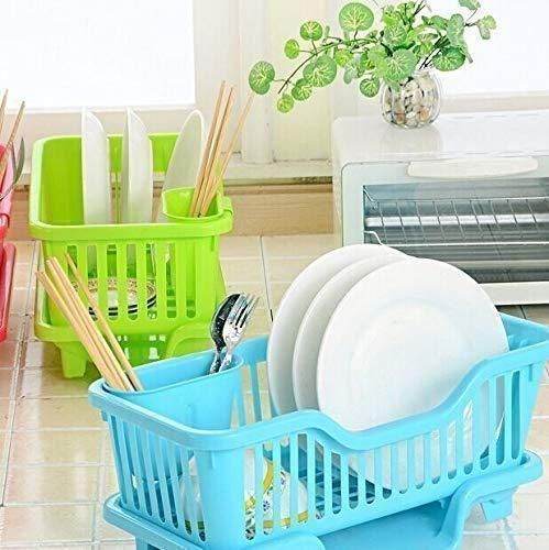Blue and green kitchen dish drainer rack holding plates, utensils, and chopsticks on a tiled countertop
