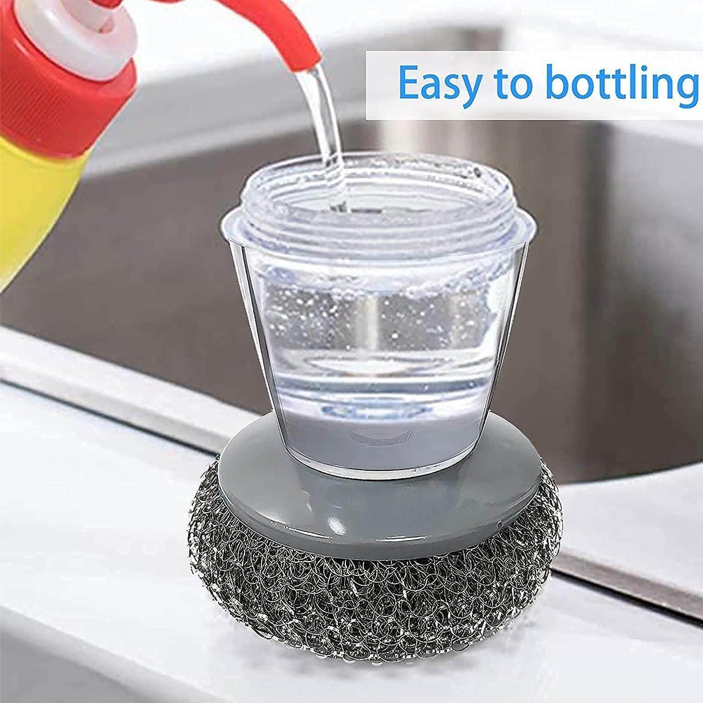Kitchen soap dispensing palm brush with clear soap container being filled near a kitchen sink