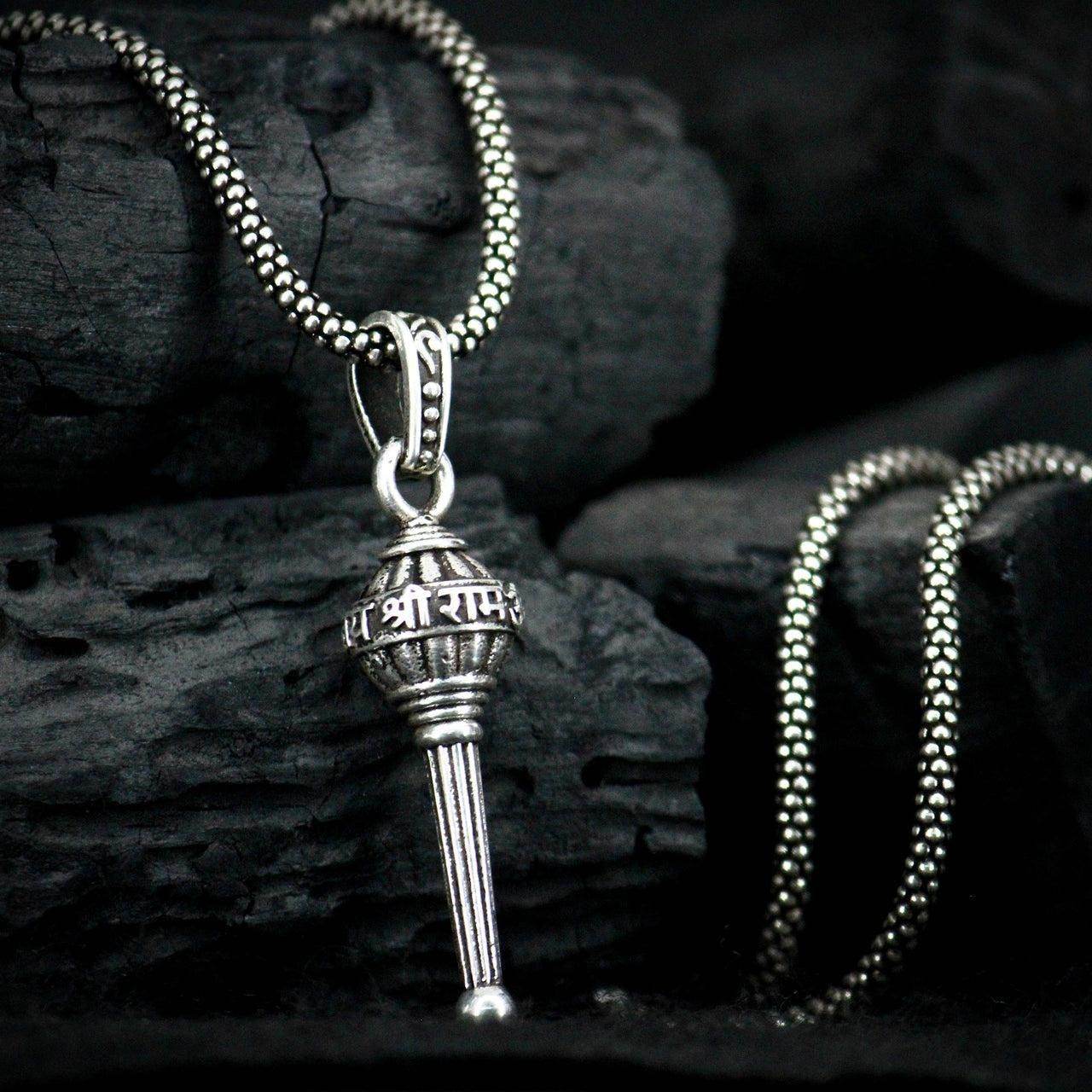 Silver Lord Hanuman pendant necklace with intricate design on a matching chain displayed on dark textured background