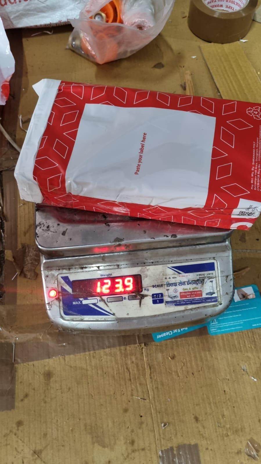 Red and white package on a digital scale displaying weight 12.39 pounds double sided pet hair removal glove