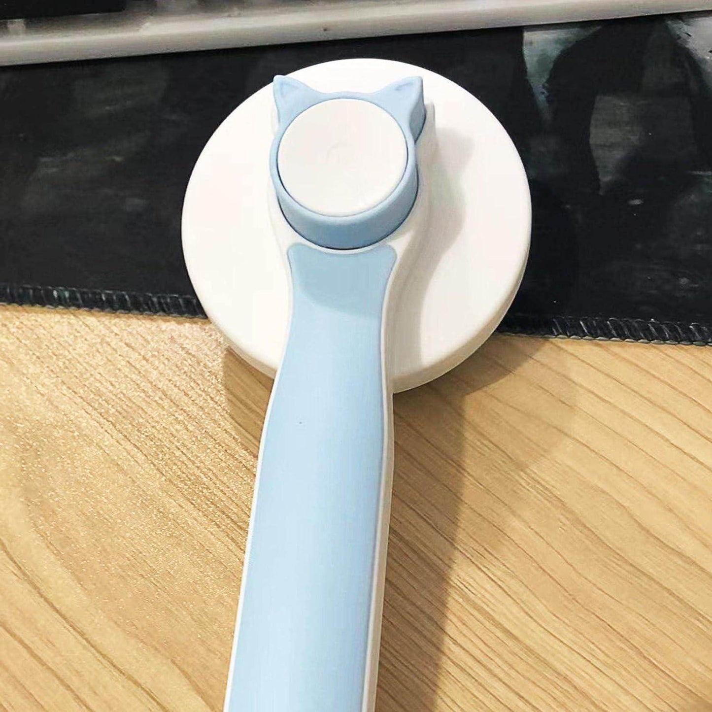 Light blue pet head comb with cleaning needle featuring a cat ear design on handle