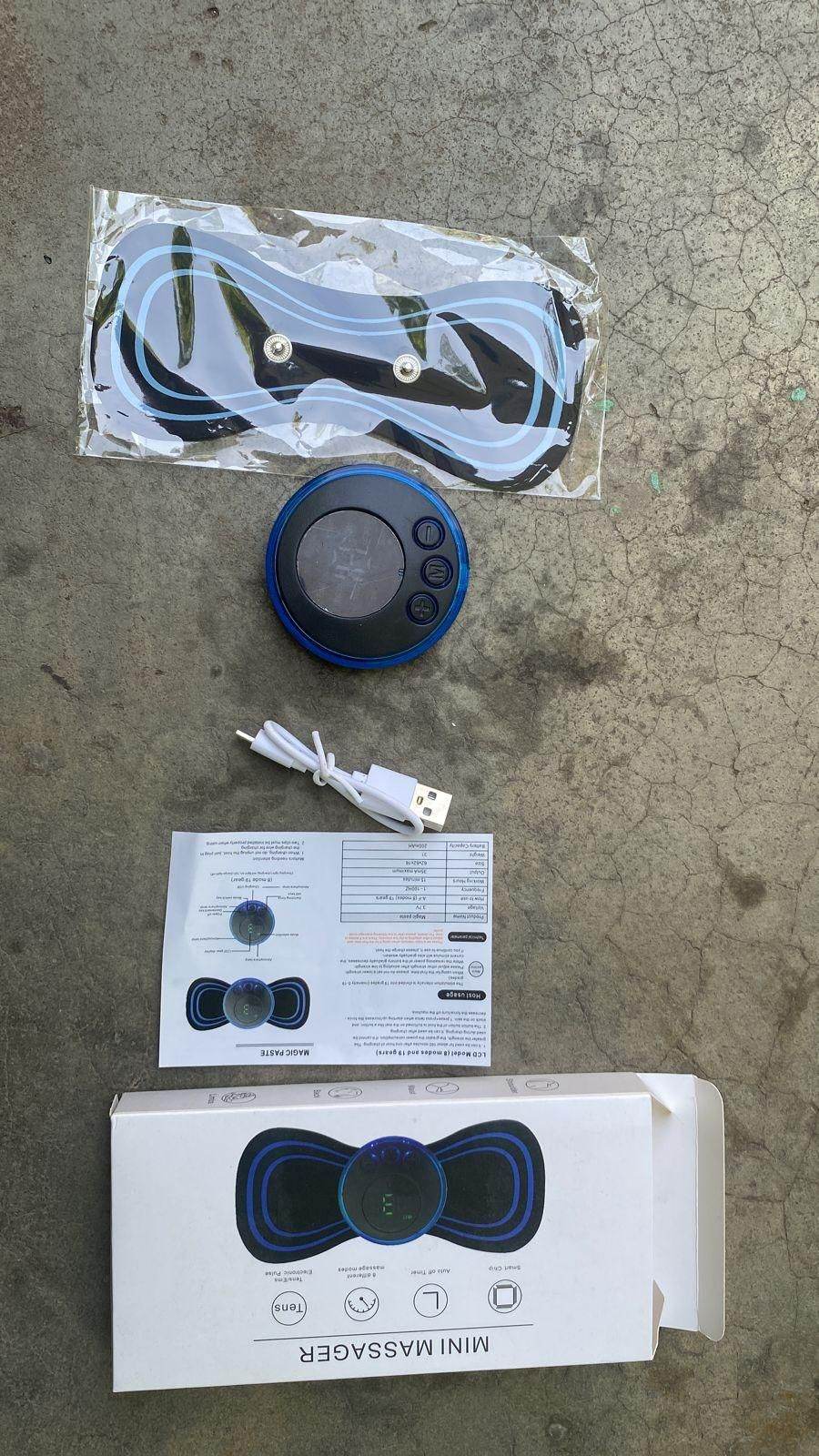 Portable wireless muscle massager with control unit, electrode pads, USB charging cable, and instruction manual
