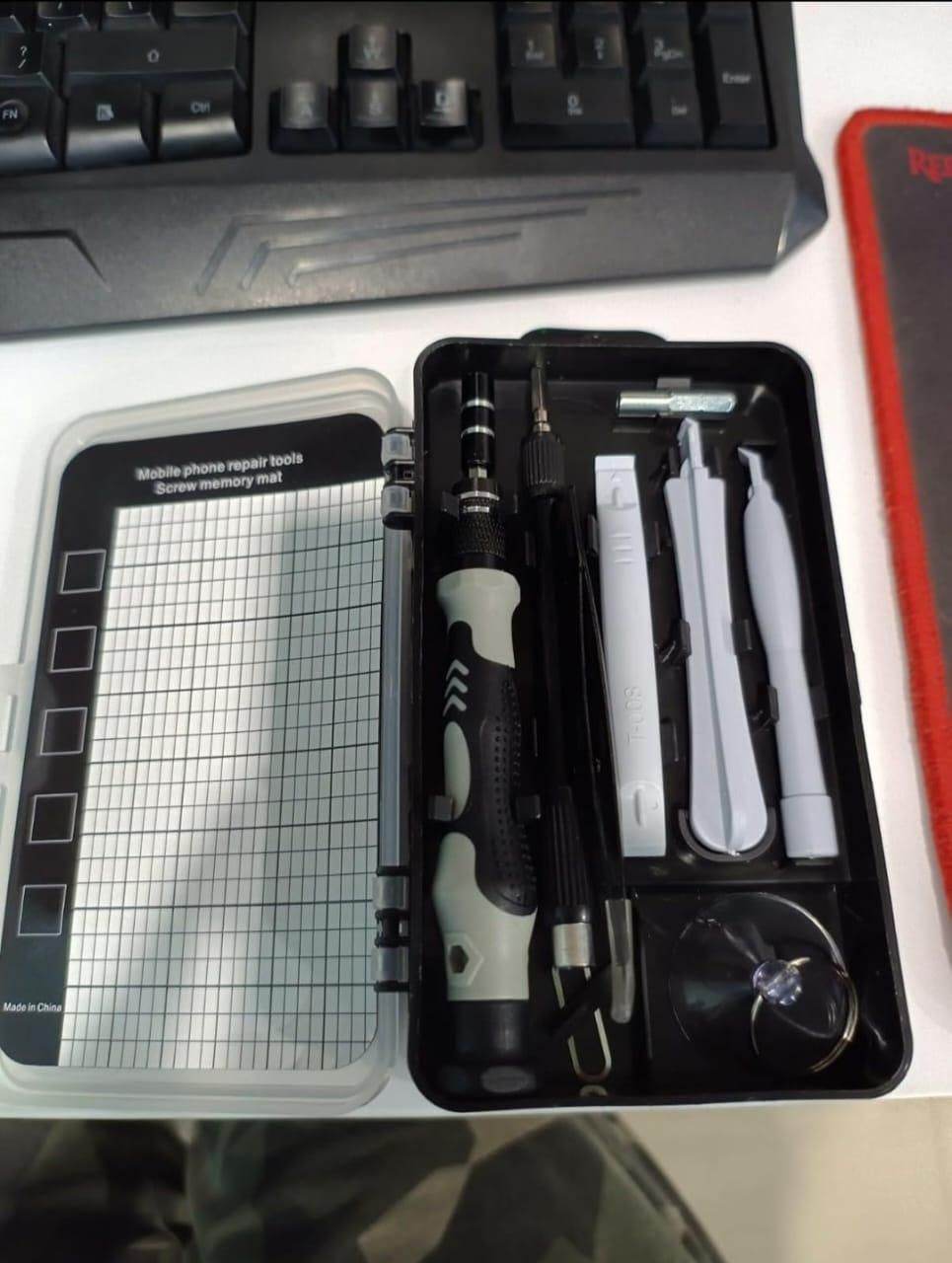 Appliance and gadget maintenance tool kit with screwdriver, pry tools, suction cup, and screw memory mat