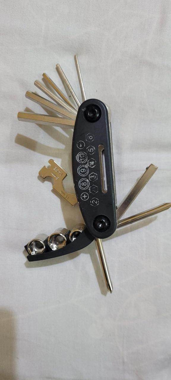Compact bicycle maintenance toolset with multiple hex keys and screwdrivers in a foldable black case