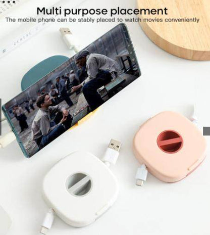 Compact USB cable holder in white and pink with phone stand feature for watching movies