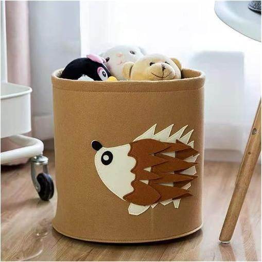 Cute foldable clothes organizer in brown with a hedgehog design holding plush toys on wooden floor