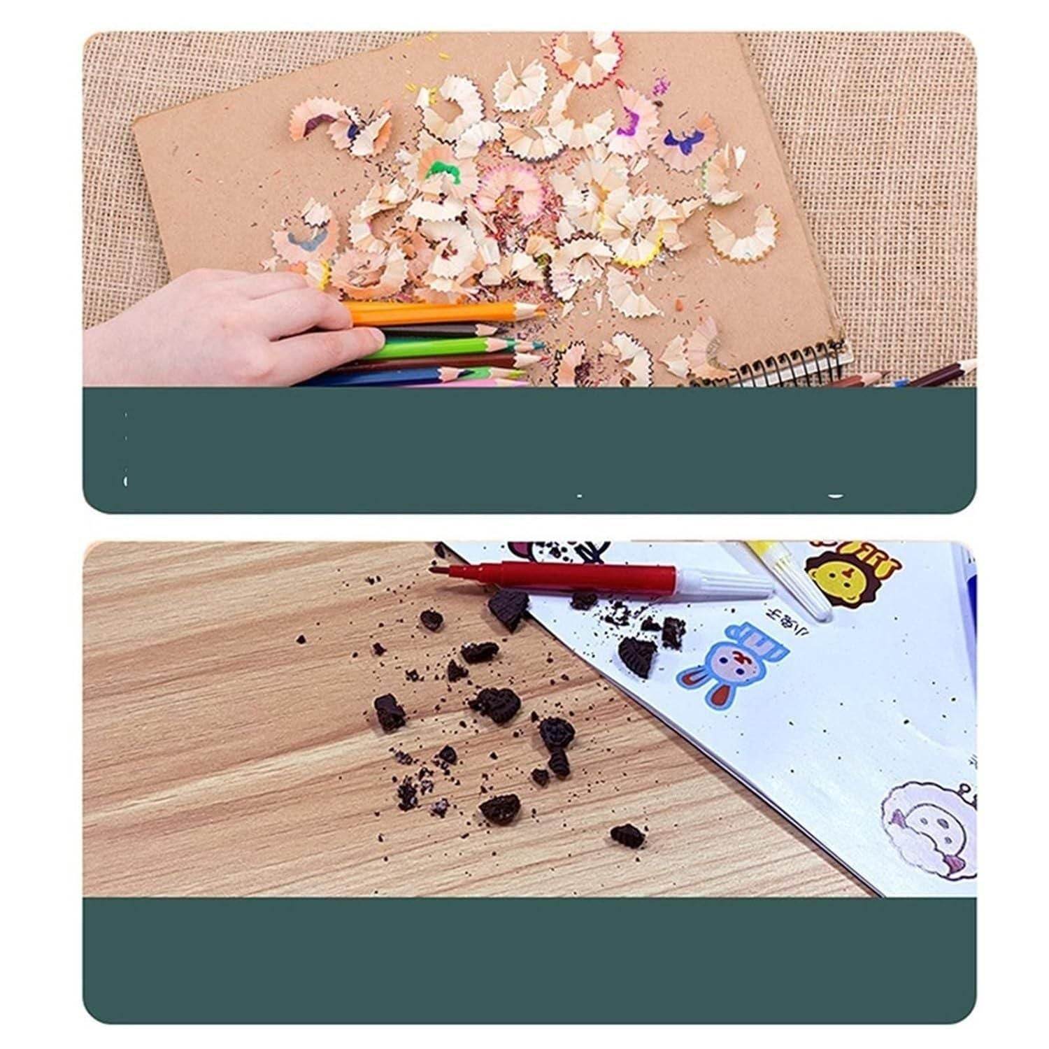 Color pencil shavings and broken colored pencil pieces on wooden surfaces with hand holding colored pencils