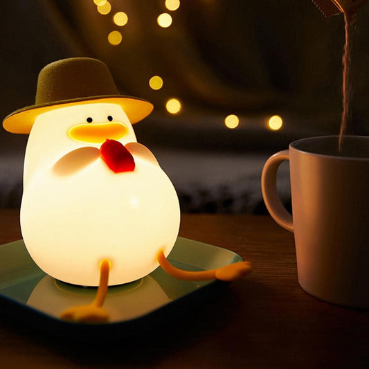 Cute duck night light shaped like a glowing chicken with a small hat sitting on a plate