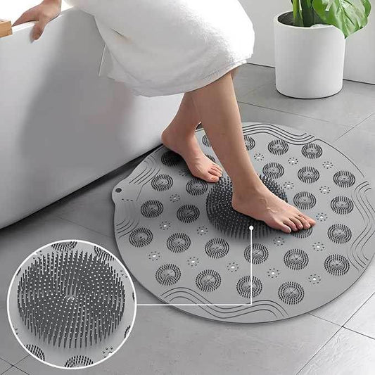 Gray foot scrubber mat for shower with soft bristles providing gentle exfoliation and massage
