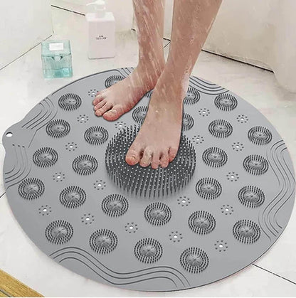Gray foot scrubber mat for shower with textured bristles used for cleaning and massaging feet in the shower