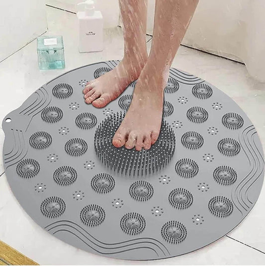 Gray foot scrubber mat for shower with textured bristles used for cleaning and massaging feet in the shower