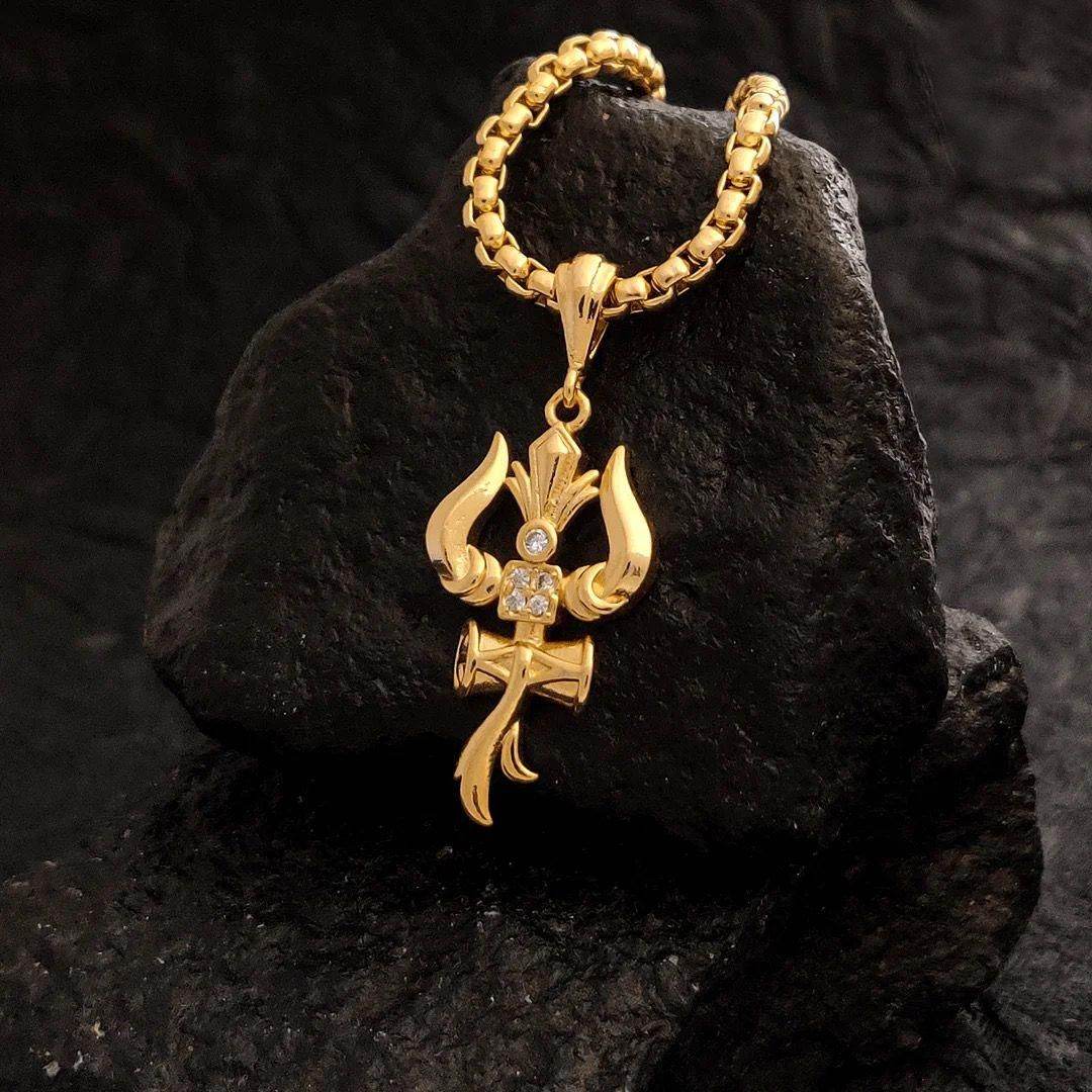 Gold Trishul pendant with chain featuring intricate design and embedded stones on black background