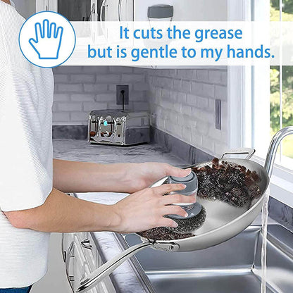 Person cleaning pan with kitchen soap dispensing palm brush that cuts grease but is gentle on hands