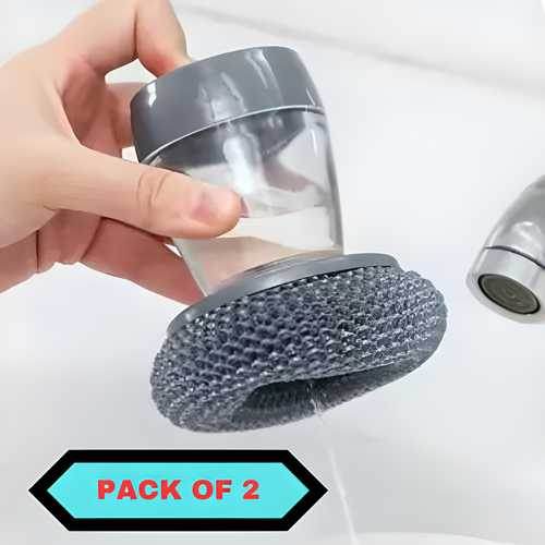 Hand holding kitchen soap dispensing palm brush with gray scrubbing pad near a sink faucet pack of 2
