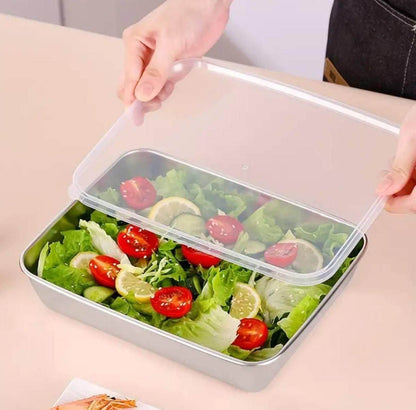 Multi-purpose kitchen container with cover holding fresh salad with lettuce cherry tomatoes and lemon slices