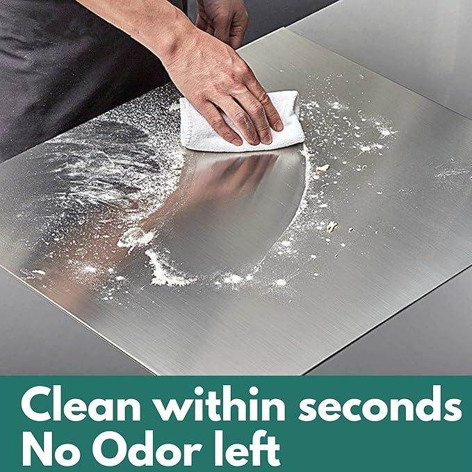 Person cleaning stainless steel chopping board with white cloth showing easy cleaning and no odor