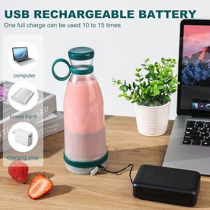 Portable mini juice blender with USB rechargeable battery charging beside laptop on wooden table