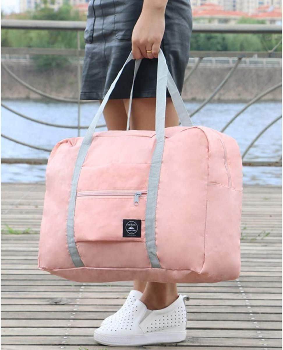 Pink foldable travel tote bag with gray handles held by a person wearing white shoes and black skirt