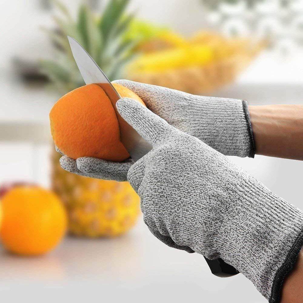 Person wearing cut-resistant gloves slicing an orange with stainless steel knives for home use